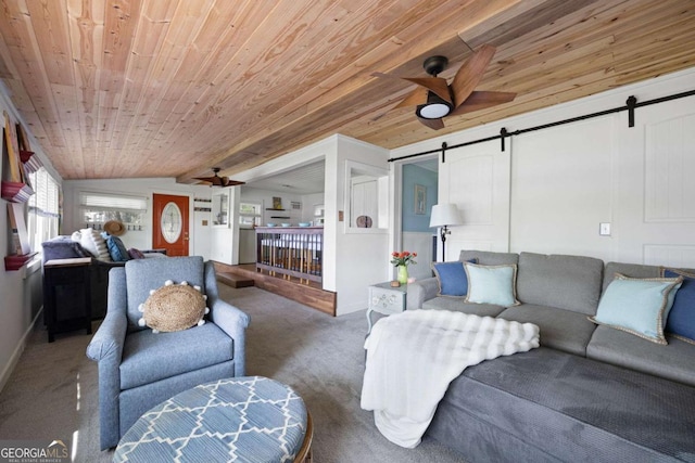 living room featuring a barn door, lofted ceiling with beams, ceiling fan, and wooden ceiling