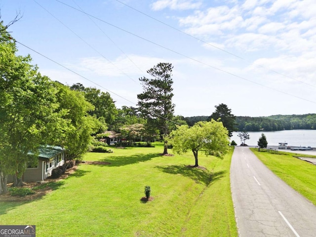 surrounding community featuring a yard and a water view