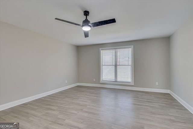 empty room with light hardwood / wood-style flooring and ceiling fan