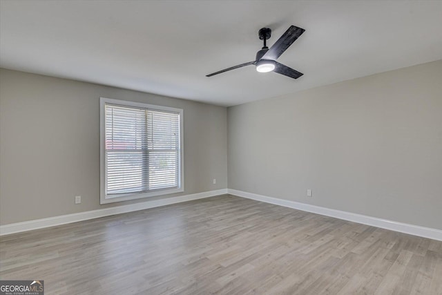 empty room featuring ceiling fan and light hardwood / wood-style flooring