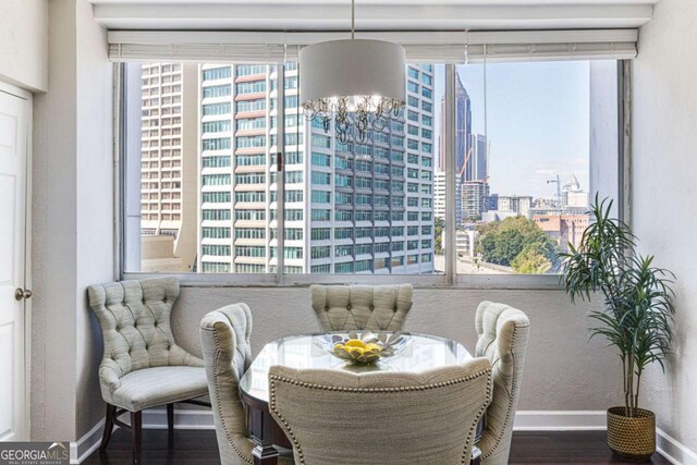 interior space with hardwood / wood-style floors, an inviting chandelier, and a wealth of natural light