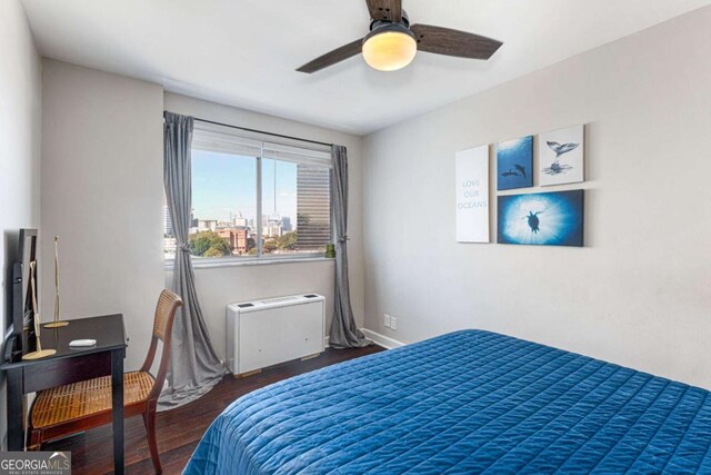 bedroom featuring ceiling fan and dark wood-type flooring