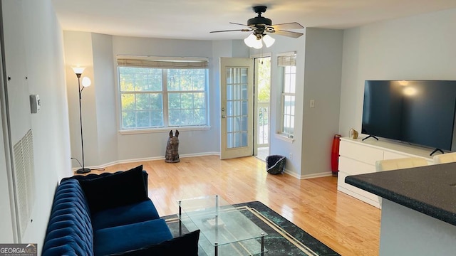 living room with hardwood / wood-style floors and ceiling fan