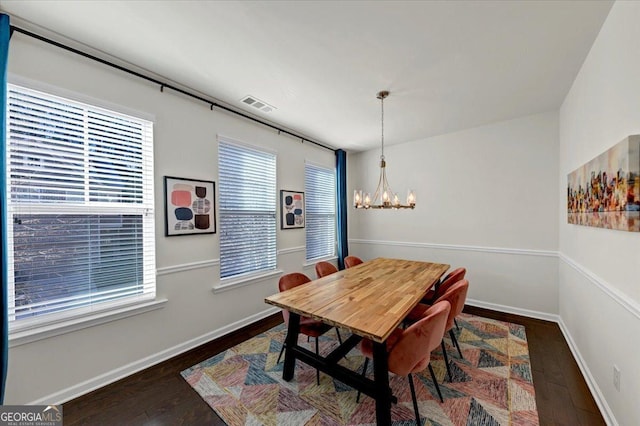 dining room with an inviting chandelier and dark hardwood / wood-style floors