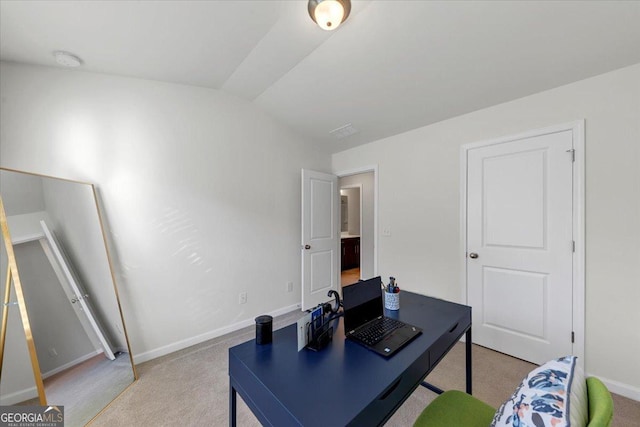 carpeted office featuring lofted ceiling