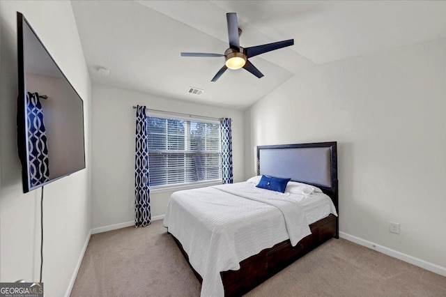 carpeted bedroom with ceiling fan and lofted ceiling