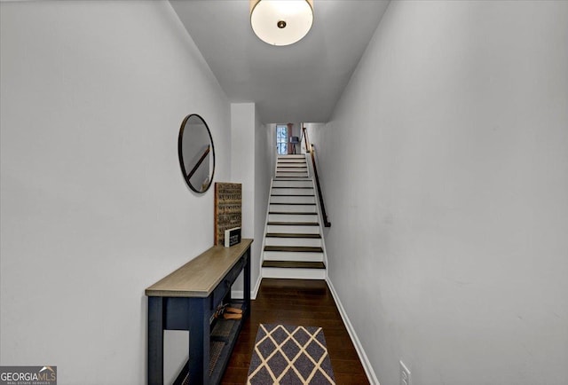 stairs featuring hardwood / wood-style floors