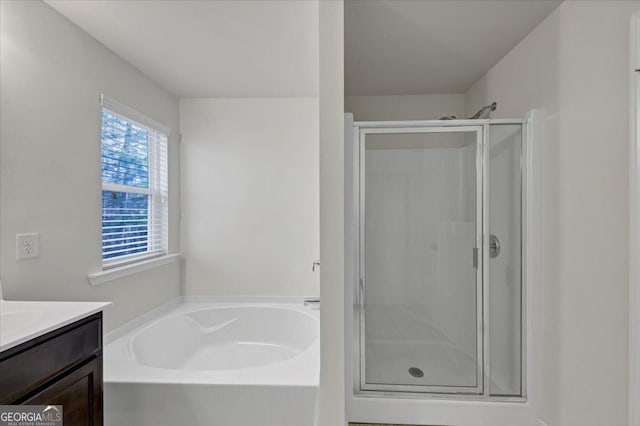 bathroom featuring vanity, plenty of natural light, and shower with separate bathtub