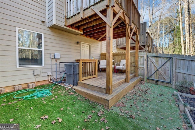 deck featuring cooling unit and a lawn