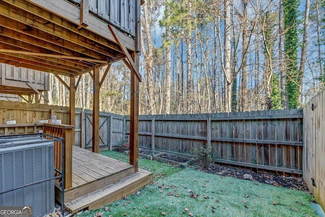 wooden terrace featuring a yard and central air condition unit