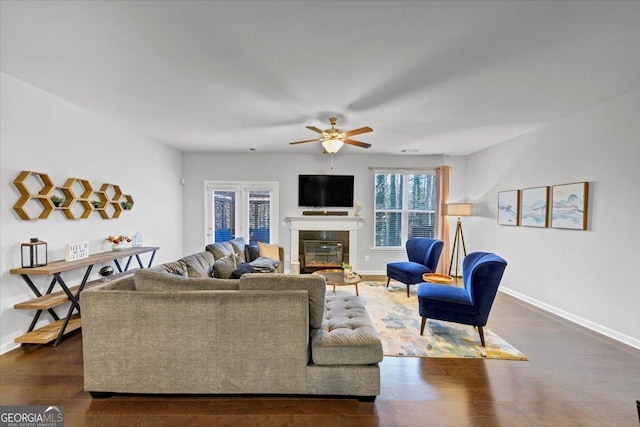 living room with ceiling fan and dark hardwood / wood-style floors