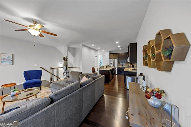 living room with ceiling fan and dark hardwood / wood-style flooring