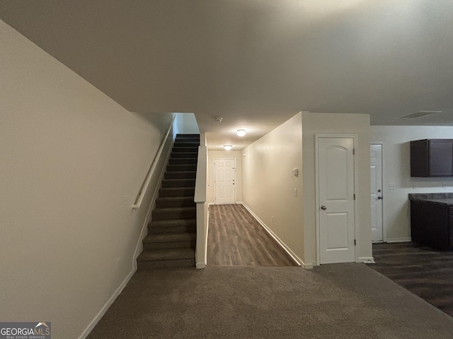 staircase featuring carpet flooring