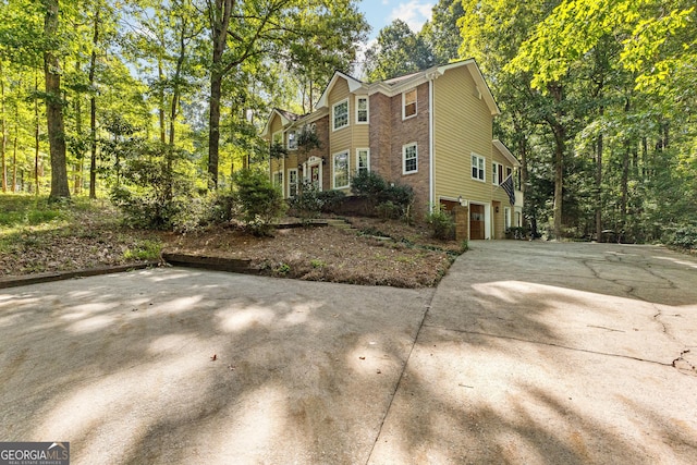 119 Castlewood Rd, Tyrone, GA 30290 - view of home's exterior featuring an attached garage, concrete driveway, and brick siding