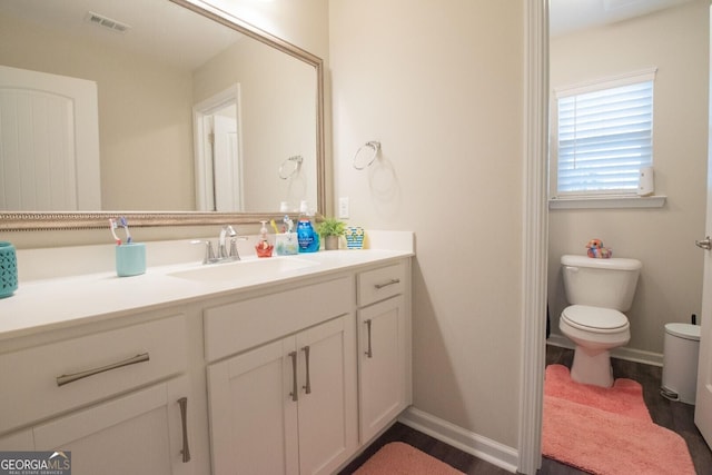 bathroom featuring vanity and toilet