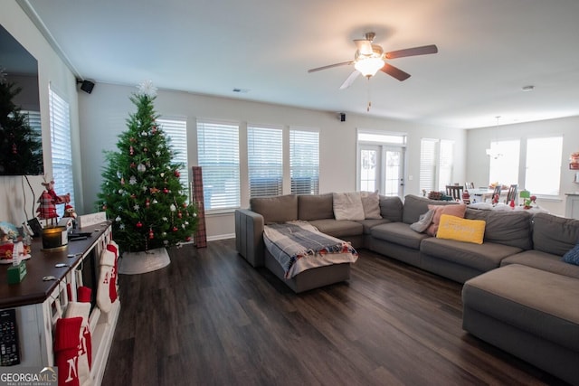 living room featuring ceiling fan and dark wood-type flooring