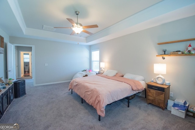 bedroom featuring a tray ceiling, ceiling fan, and carpet floors