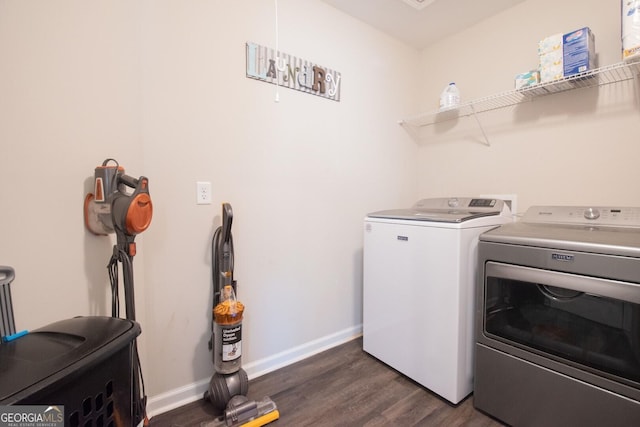 laundry area with washing machine and dryer and dark wood-type flooring