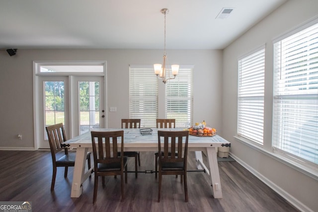 dining area with a chandelier, dark hardwood / wood-style flooring, and a healthy amount of sunlight