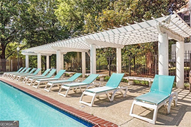 view of patio with a pergola and a community pool