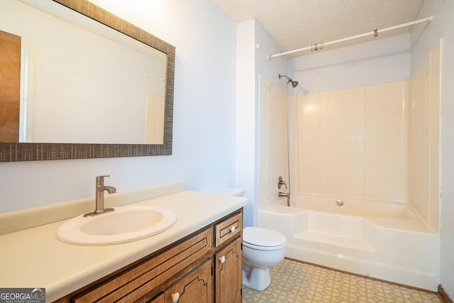 full bathroom with a textured ceiling, vanity, toilet, and tub / shower combination