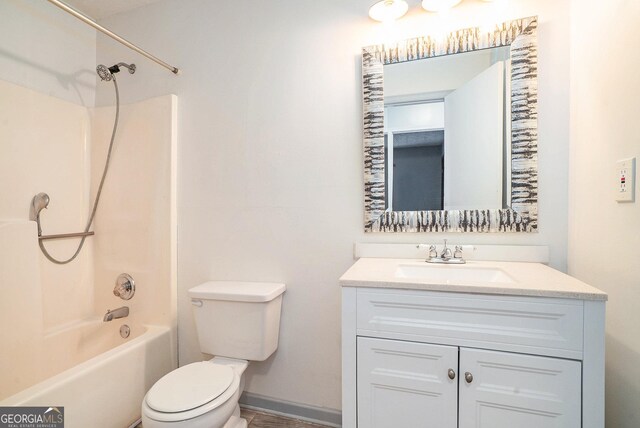 full bathroom featuring toilet, vanity, and tub / shower combination