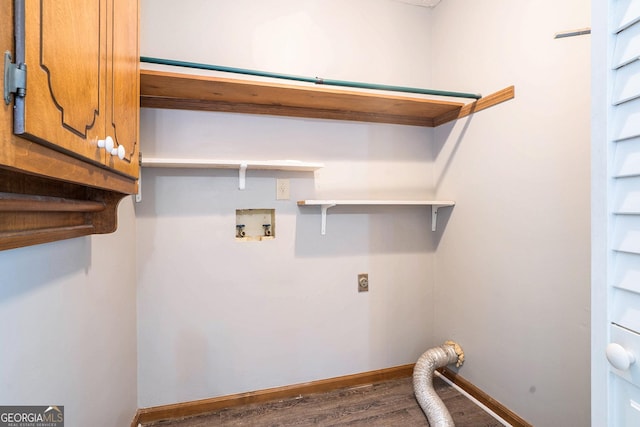 clothes washing area with electric dryer hookup, washer hookup, cabinets, and wood-type flooring