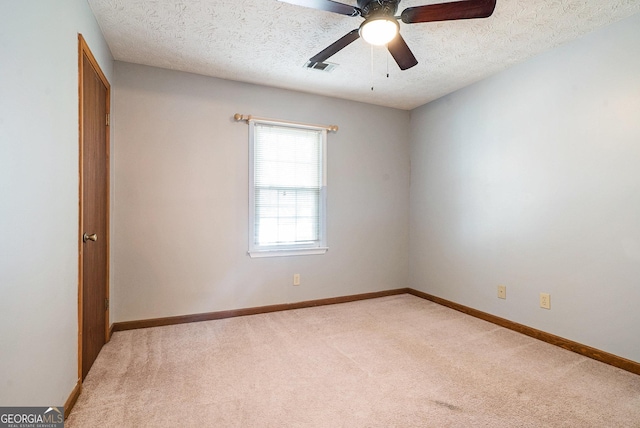 carpeted empty room featuring a textured ceiling and ceiling fan