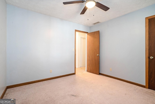 spare room featuring ceiling fan and a textured ceiling