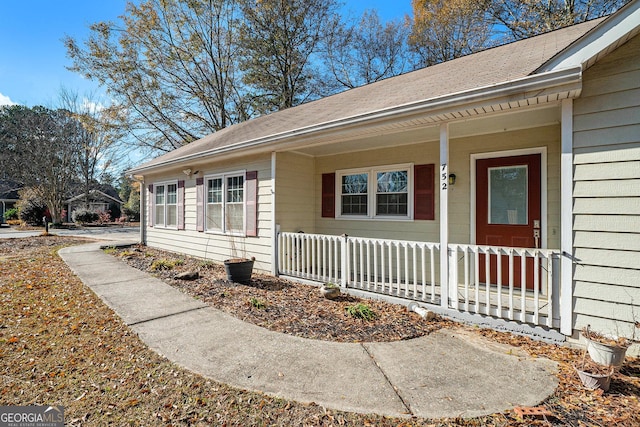 view of exterior entry featuring a porch