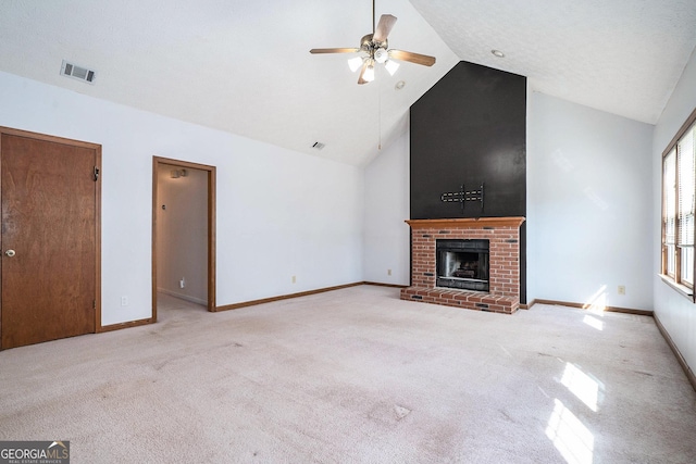 unfurnished living room featuring ceiling fan, a fireplace, high vaulted ceiling, and light carpet