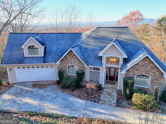 view of front of property featuring a mountain view and a garage