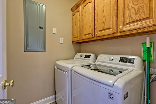 washroom featuring cabinets, washer and dryer, and electric panel