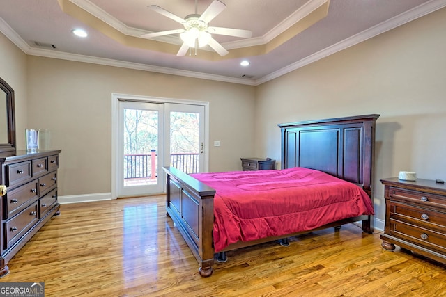 bedroom featuring a raised ceiling, access to outside, ornamental molding, and ceiling fan