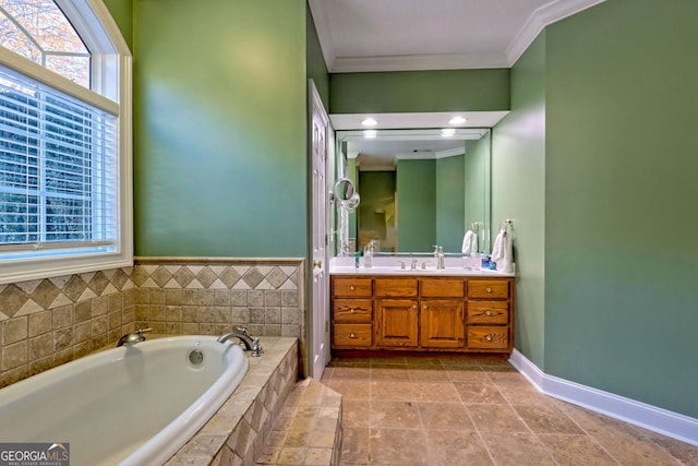 bathroom featuring vanity, crown molding, and tiled tub