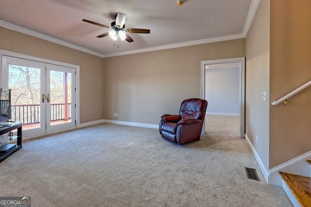 sitting room featuring ceiling fan, light colored carpet, french doors, and crown molding