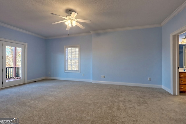 carpeted spare room featuring ceiling fan, a wealth of natural light, and crown molding