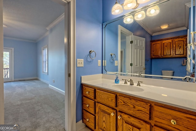 bathroom featuring toilet, crown molding, and vanity