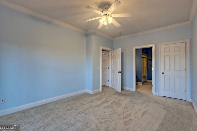 unfurnished bedroom featuring ceiling fan, light carpet, and crown molding