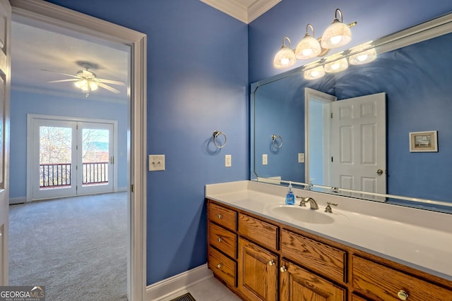 bathroom with ceiling fan, vanity, and crown molding