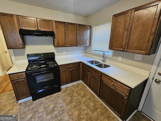 kitchen featuring black range with electric stovetop and sink