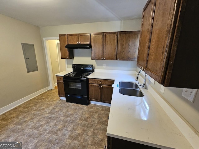 kitchen featuring black range with electric stovetop, dark brown cabinets, sink, and electric panel