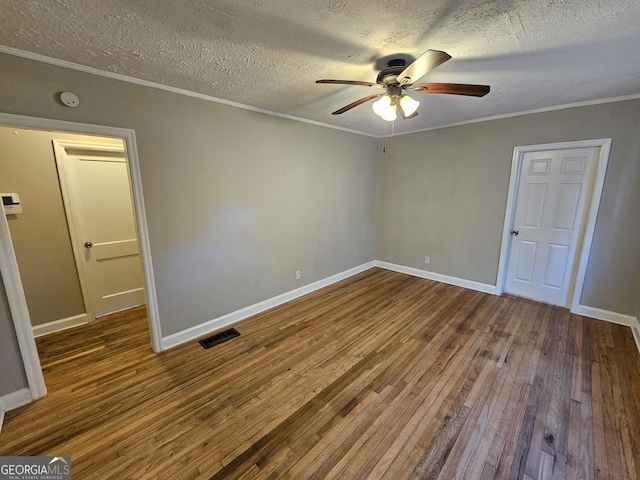 spare room featuring ornamental molding, ceiling fan, a textured ceiling, and wood-type flooring