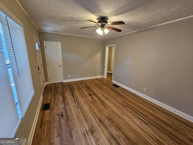 spare room with ornamental molding, ceiling fan, a textured ceiling, and hardwood / wood-style flooring