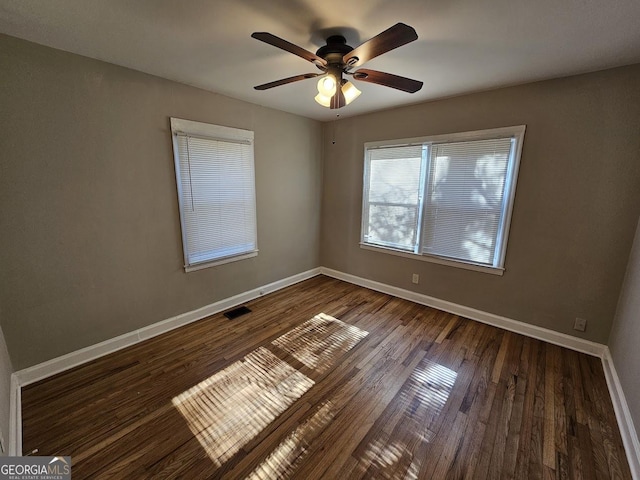 unfurnished room featuring ceiling fan and dark hardwood / wood-style flooring