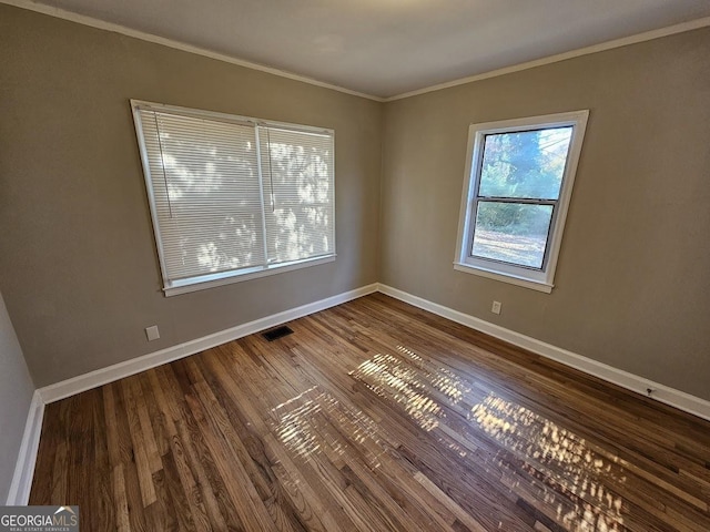 unfurnished room featuring ornamental molding and hardwood / wood-style flooring