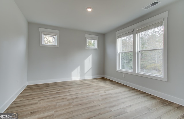 spare room featuring light wood-type flooring