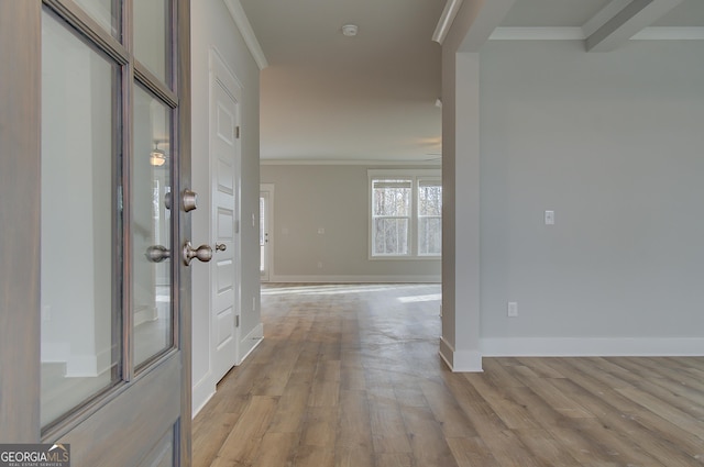 hall featuring crown molding and light wood-type flooring