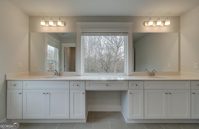 bathroom featuring tile patterned flooring and vanity