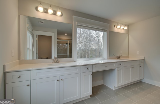 bathroom with tile patterned flooring, vanity, an enclosed shower, and toilet